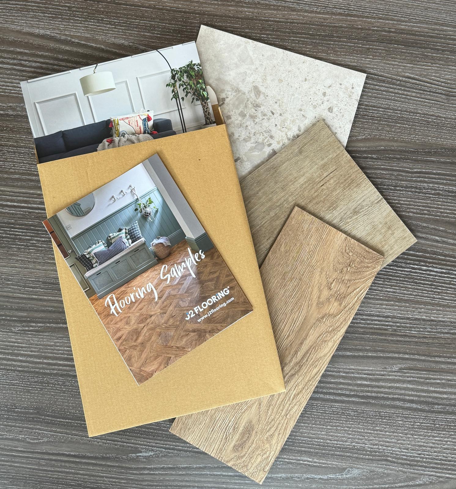 A birds-eye view of three LVT flooring samples on the floor.